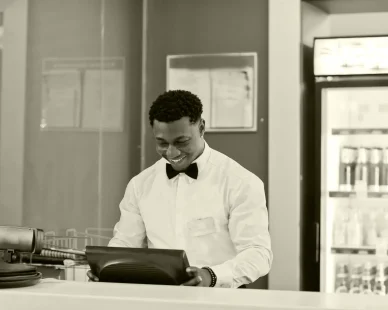 african-american-bartender-wear-bow-tie-using-cash-terminal-screen-bar-1