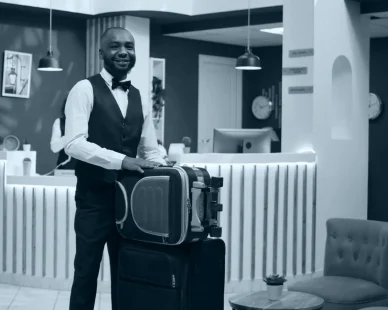 african-american-bellboy-takes-suitcases-e1738064352665