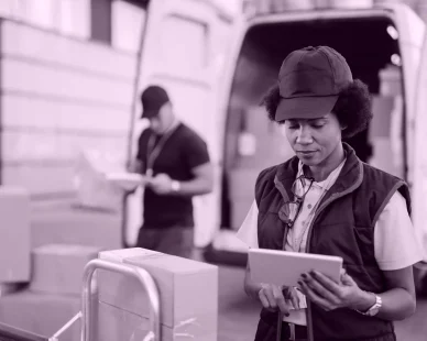 african-american-female-worker-making-inventory-packages-organizing-delivery-schedule-digital-tablet-her-colleague-is-working-background