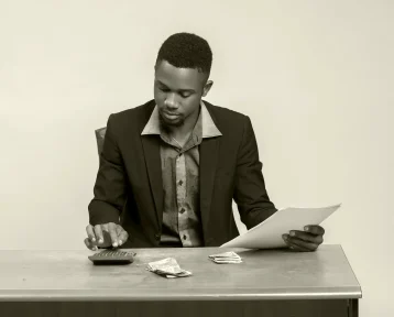 african-businessman-seriously-analyzing-budget-his-hand