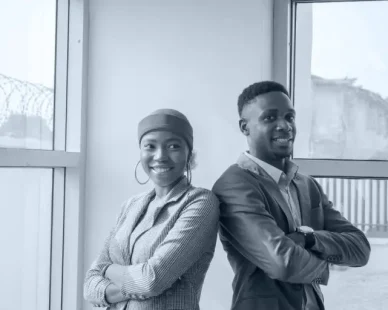 closeup-two-business-partners-standing-side-by-side-smiling-1-768x512