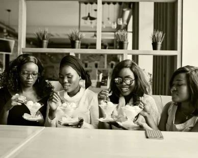 four-african-american-girls-sitting-table-cafe-eating-ice-cream-dessert