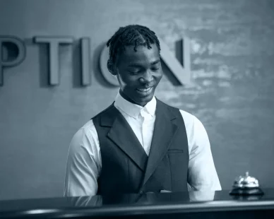 front-view-smiley-man-working-reception