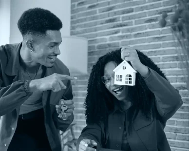 happy-multiracial-couple-showing-mini-wooden-house-key-with-key-ring