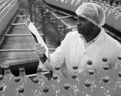 male-worker-reading-clipboard-while-inspecting-bottles-juice-factory-scaled-3