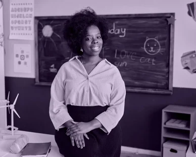 portrait-smiling-primary-school-teacher-classroom