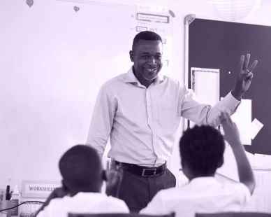 teacher-showing-hand-front-elementary-school-class