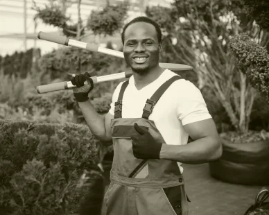 young-african-american-gardener-cuts-tree-with-scissors-gardening-tree-shop-concept-e1738057775553